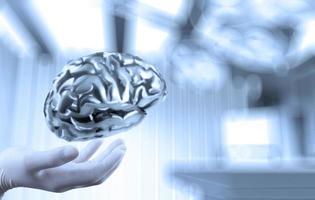 doctor neurologist hand show metal brain with computer interface as concept photo