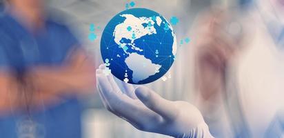 Medical Doctor holding a world globe in her hands as medical network concept photo