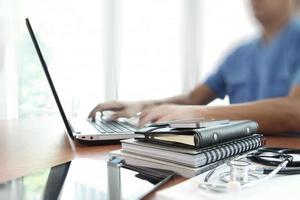 Doctor working with laptop computer in medical workspace office as concept photo