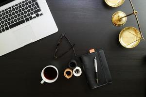 justice and law concept.Lawyer workplace with laptop and documents with dark wooden photo