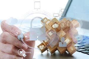 businessman hand pointing to padlock on touch screen computer as Internet security online business concept and bokeh exposure photo