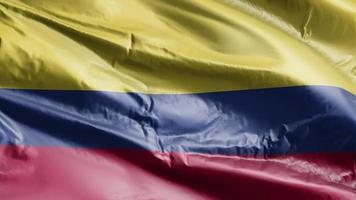 Colombia vlag zwaaien op de wind-lus. Colombiaanse banner zwaaiend op de wind. volledige vulling achtergrond. 10 seconden lus. video