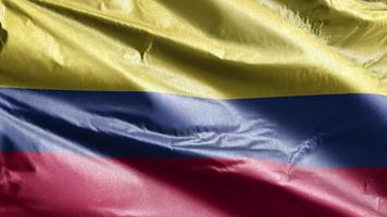 Colombia textile flag slow waving on the wind loop. Colombian banner smoothly swaying on the breeze. Fabric textile tissue. Full filling background. 20 seconds loop. video