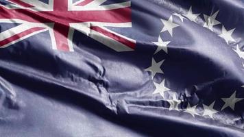 Cook Island têxtil bandeira acenando no loop de vento. Cook Island banner balançando a brisa. tecido tecido têxtil. fundo de preenchimento completo. loop de 10 segundos. video
