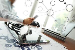 Doctor working with laptop computer in medical workspace office and medical network media diagram as concept photo