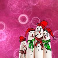 A lovely family hand drawn and finger of snowmen on flowers nature background as concept idea photo