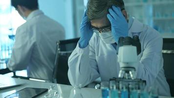 Depressed and stressful scientists  in laboratory, Science and technology healthcare concept video