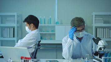 Depressed and stressful scientists  in laboratory, Science and technology healthcare concept video