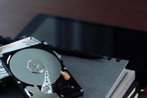 Close up of open computer hard disk drive on notebook photo