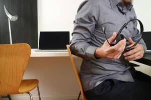 Man using VOIP headset with digital tablet and laptop computer as concept communication,it support,call center and customer service help desk photo