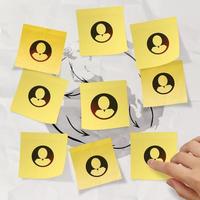 hand pushing sticky note social network icon on crumpled paper background as concept photo
