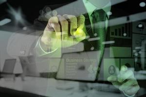 Double exposure of businessman hand working with new modern computer and business strategy as concept photo