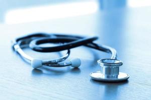 Studio macro of a stethoscope and digital tablet with shallow DOF evenly matched abstract on wood table background copy space photo