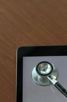 studio macro of a stethoscope and digital tablet on wood table background copy space photo