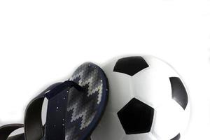 Slippers and a soccer ball iasolate on white background photo