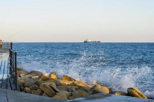 Mediterranean waves beat the shore near the city of Limassol in Cyprus. photo