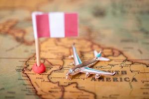 the flag of Peru and the plane on the world map. photo