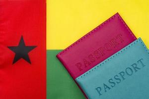 Against the background of the flag of Guinea-Bissau is a passport. photo