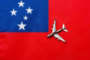 Plane over the flag of Samoa the concept of travel and tourism. photo