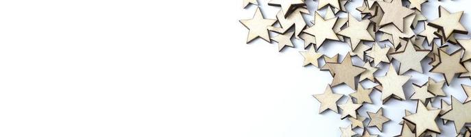 A lot of wooden stars on a white background. Copy Space. photo