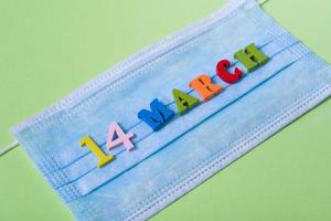 Wooden letters on March 14 on a medical mask. photo