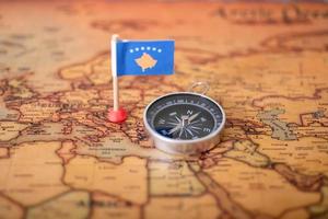 Flag of Kosovo and compass on the world map. photo