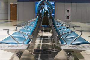 Seats without people in airport waiting building. photo