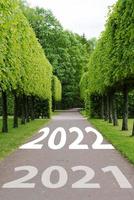 The concept of a road for business planning,the Word 2022, written on the road in the middle of trees in the park. photo