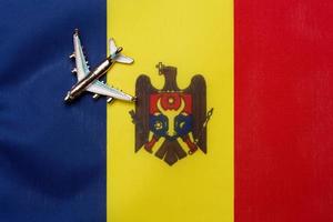 The plane over the flag of Moldova is the concept of travel and tourism. photo