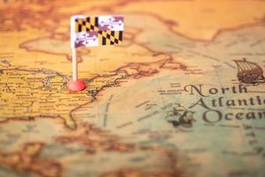 The flag of Maryland on the old world map. photo