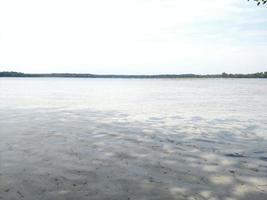 Overview of the lake and sand shoreline photo