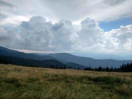 Mountains ate clouds and lawn Grassland with dry grass photo