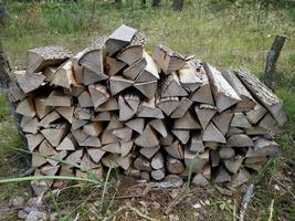 Preparation of firewood . Background. Firewood in the forest. Firewood on camping area fireplace. Stacks of firewood. photo