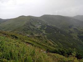 cadenas montañosas en tiempo nublado cerca del lago foto