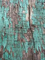 The texture of cracked blue paint on wood . photo