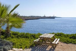 Picnic bench Overlooking the Sea on a summer day. photo