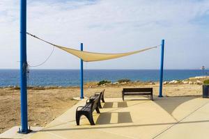 Benches overlooking the sea on the island of Cyprus, near Paphos. photo