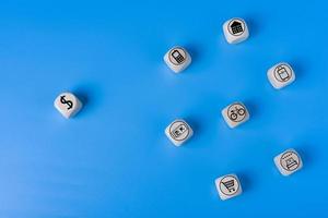 Vacation concept with icons on wooden cubes, blue background. photo