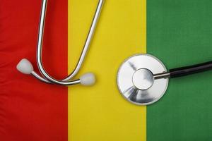 Guinea flag and stethoscope. The concept of medicine. photo