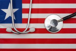 Flag of Liberia and stethoscope. The concept of medicine. photo