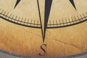 The compass is drawn on a concrete slab. photo