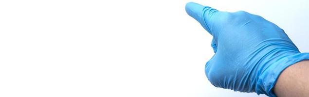 The gloved hand points with the index finger. Place under the text. photo