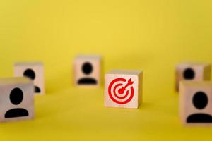 The target is on wooden cubes, around the target are signs of people on wooden cubes, yellow background. photo