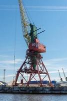 Many tall cargo cranes stand on the banks of the Venta River. Ventspils, Latvia, Baltic Sea. photo