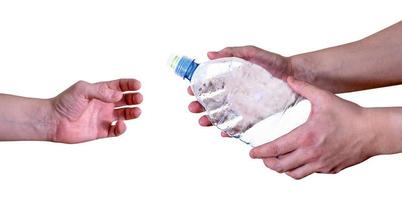 A man passes an empty, plastic bottle, isolated on a white background. photo