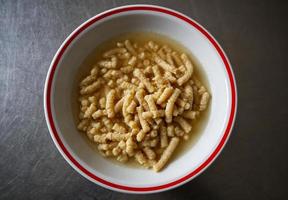 Homemade Italian Passatelli. Traditional Italian pasta cooked in broth. View from above. Bologna, Italy. photo