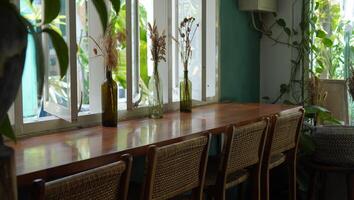 The window seat with a wooden desk decorated with dried flowers. photo