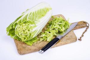 Sliced fresh green chinese cabbage on wooden cutting board. Studio Photo