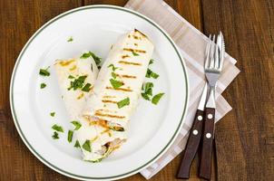 Thin lavash with vegetables and chicken on plate, shawarma. Studio Photo