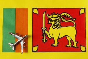 Airplane over Sri Lanka flag travel concept. photo